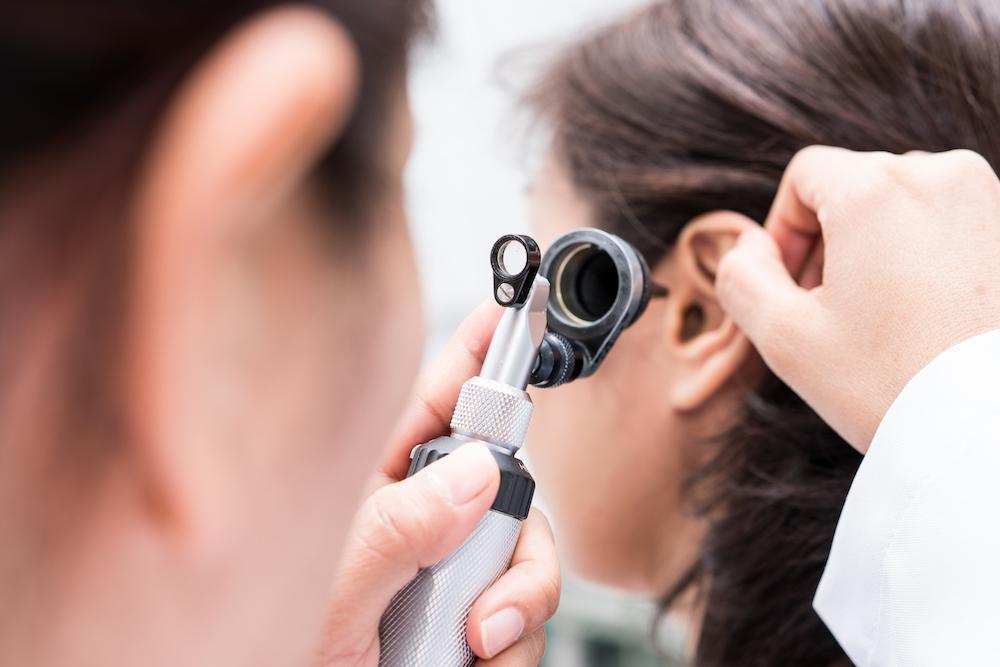 Woman having her ear examined