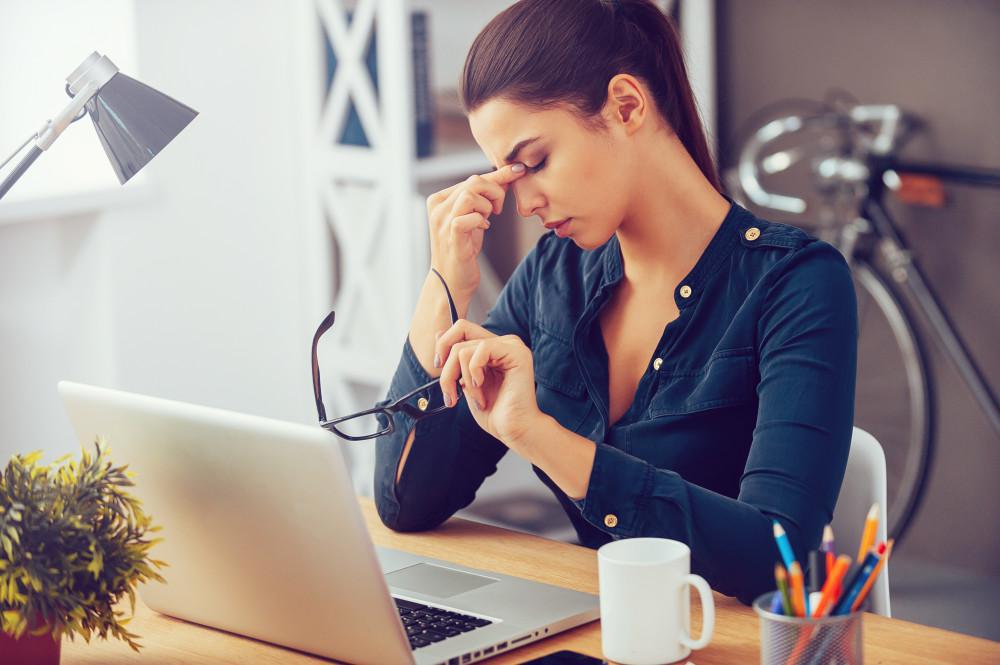 Woman at a computer suffering from eye strain