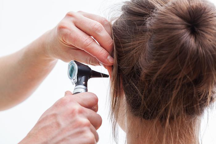 Woman having ear examined