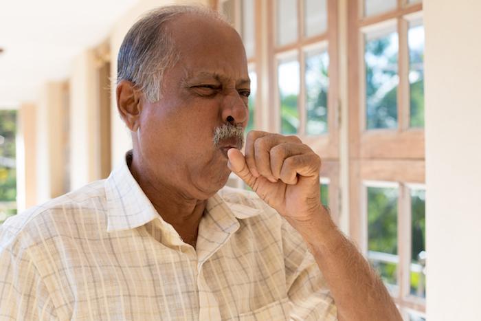 Man coughing into his hand